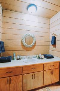 a bathroom with a sink and a mirror at Baja Vineyard Lodge - Luxury in Valle de Guadalupe with pool in Ensenada