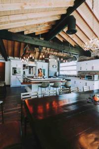 a large kitchen with a table and chairs at Baja Vineyard Lodge - Luxury in Valle de Guadalupe with pool in Ensenada