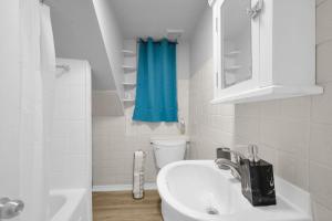 baño con lavabo y cortina de ducha azul en Stylish 3 BR Apt with Free Parking, Wifi and Patio, en Whitby 30 fotos más