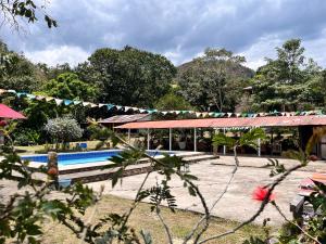 a resort with a swimming pool and a building at La Granja De Bam Bam in Sasaima