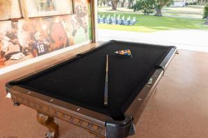 a pool table sitting in front of a wall at Spacious Luxury Estate Pool Jacuzzi Horses in Orlando +5 photos