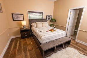 a bedroom with a bed with a table and a mirror at Spacious Luxury Estate Pool Jacuzzi Horses in Orlando