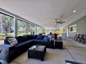 a living room with a blue couch and a ceiling fan at Peaceful Country Getaway Near Casino Shopping in Diamond Springs