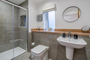 a bathroom with a sink and a toilet and a shower at Schiehallion by Loch Tay in Chesthill +20 photos