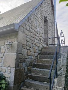 a set of stairs outside of a stone building at Proche parc 3 curés in Coatéval