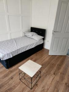 a bedroom with a bed and a coffee table at Okwute,s House in Skelmersdale