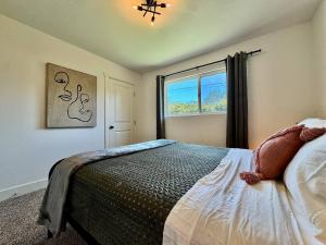 a bedroom with a bed and a window at Pool Remodeled 4 Bedroom Carmichael Home in Carmichael +33 photos