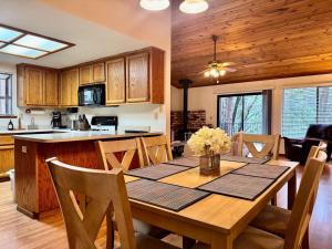 a kitchen and dining room with a table and chairs at Forest View Family Home in Pollock Pines
