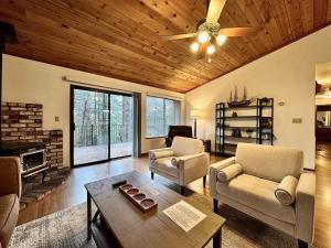 a living room with a couch and chairs and a table at Forest View Family Home in Pollock Pines