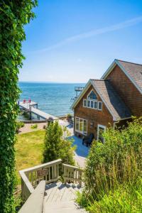 a house on the beach with a view of the ocean at Drift Away Hot Tub Kayaks Lakefront & Games in Teall Beach