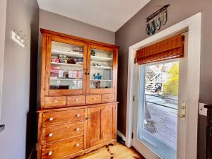 a kitchen with a wooden cabinet and a window at Drift Away Hot Tub Kayaks Lakefront & Games in Teall Beach