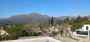 a view of a town with mountains in the background at Tu Lugar en Capilla Del Monte in Capilla del Monte