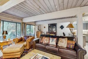 a living room with a leather couch and a table at Interlochen #B9 in Vail
