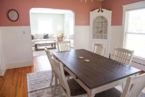 een eetkamer met een houten tafel en stoelen bij The Homestead Historic Charm & Big Backyard in Geneva