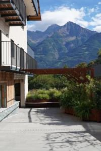 a patio with a view of mountains in the background at La Dimora delle Nevi in Aosta