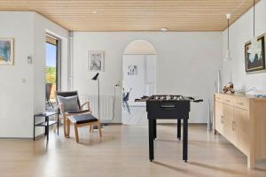 a living room with a table and a chessboard on the floor at 2702-Romo-Drosselvej-13 in Sønderby