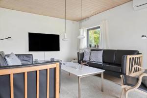 a living room with a couch and a table at 2702-Romo-Drosselvej-13 in Sønderby