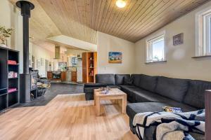 a living room with a couch and a table at C11358-Tarm-Tyttebaervej-23 in Højsand