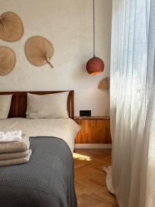 a bedroom with a bed and a curtain at Wabi Sabi Retreat - 5 min from Palas of Culture in Iaşi