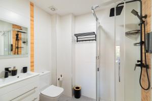 a bathroom with a shower and a toilet at Baiona by Ladeira in Baiona +5 photos