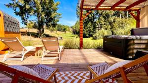 a patio with chairs and a table and a grill at Chalet Zénaé - Chalet Cosy avec spa & Sauna in Vitrac