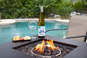 a bottle of wine and a glass and a fire pit at Lakeview on Main Pool Fire Pit and Walkable in Geneva