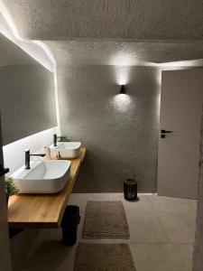 a bathroom with two sinks on a wooden counter at Chill room PLUS in Golčŭv Jeníkov