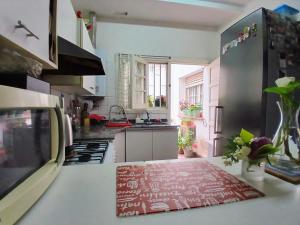 a kitchen with a red and white rug on a counter at Habitación privada zona Centro, Tribunales y Patio Olmos in Cordoba