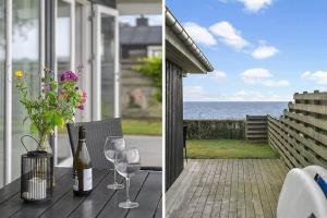 a table with wine glasses and a vase of flowers at SJ308-Sjolund-Gl-Strandvej-29 in Binderup Strand