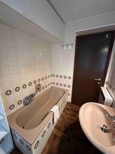 a bathroom with a bath tub and a sink at Studio on the ski slopes in Passo del Tonale