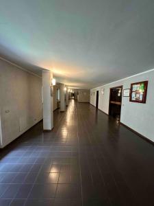 an empty hallway with a tile floor in a building at Studio on the ski slopes in Passo del Tonale