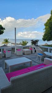 a patio with tables and chairs on the beach at Hotel Dona Ana in Vilanculos