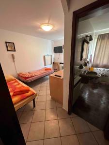 a small room with two beds and a kitchen at Studio on the ski slopes in Passo del Tonale +4 photos