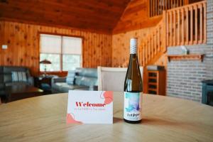 a bottle of wine sitting on top of a table at Waterside Leisure Lakefront Hot Tub & Game Room in Teall Beach +35 photos