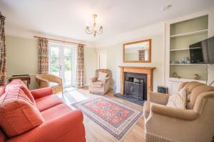 a living room with two couches and a fireplace at Mount Pleasant Farm, Dunwich in Dunwich