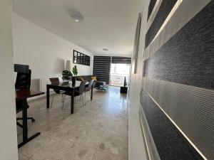 a living room with a table and a dining room at Suite 52 - Two Bedroom Apartment with Shared Pool in Nicosia