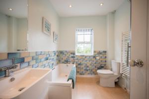a bathroom with a tub and a toilet and a sink at Mount Pleasant Farm, Dunwich in Dunwich +49 photos