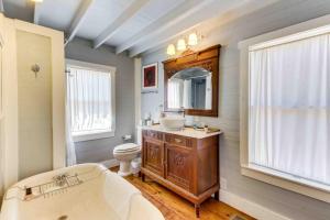 a bathroom with a tub and a sink and a toilet at Travis Street in Fredericksburg +30 photos