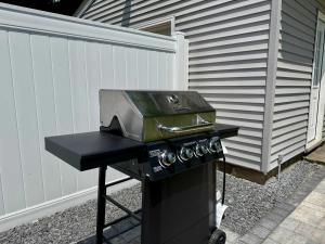 a barbecue grill with a pan on top of it at Jefferson & Grounds 3BR Steps from HWS and Hot Tub in Geneva