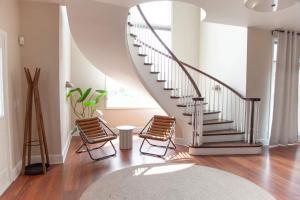 a living room with two chairs and a staircase at Luxury Lakeview Retreat Hot Tub Gym & Theatre in Grange Landing