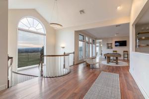 a living room with a table and a large window at Luxury Lakeview Retreat Hot Tub Gym & Theatre in Grange Landing