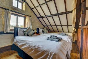 a bedroom with a large bed with towels on it at Pilgrims Prospect in Bacton +26 photos
