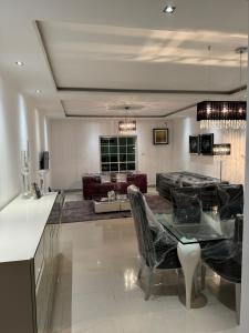 a living room with a table and a couch at Apartamento T3 in Camama