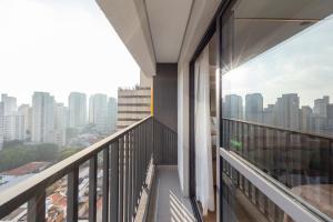 a balcony with a view of a city at B Homy Librio in São Paulo