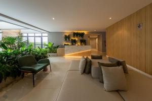 a living room with a couch and some plants at B Homy Librio in São Paulo +17 photos