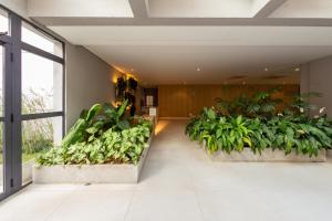 a hallway with plants in a building at B Homy Librio in São Paulo