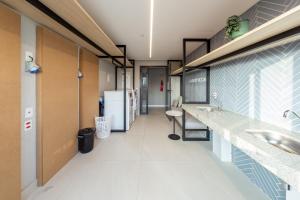 a hospital hallway with a sink and a refrigerator at B Homy Librio in São Paulo