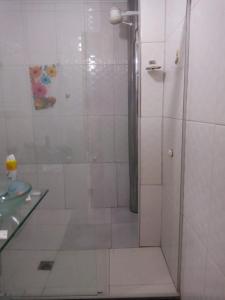 a shower in a bathroom with a glass counter at Casa princesa isabel in Porto Seguro +6 photos