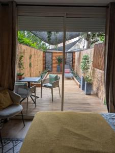 a bedroom with a deck with a table and chairs at Studio avec terrasse privative in Albi