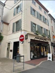 a building with a street sign in front of it at Le studio Grande Maison Perrier in Montbrison